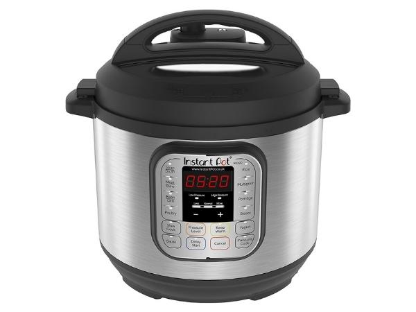 A stainless steel electric pressure cooker, this Instant Pot features a digital display showing "05:20." With a black lid, side handles, and labelled control panel, it’s easy to get started with various cooking functions and settings.