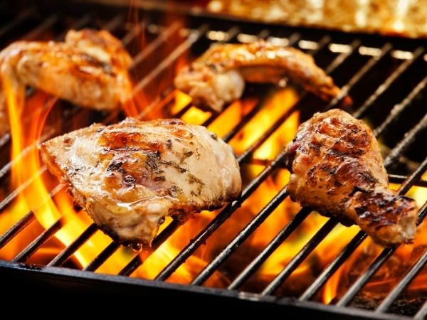 chicken on a bbq with flames