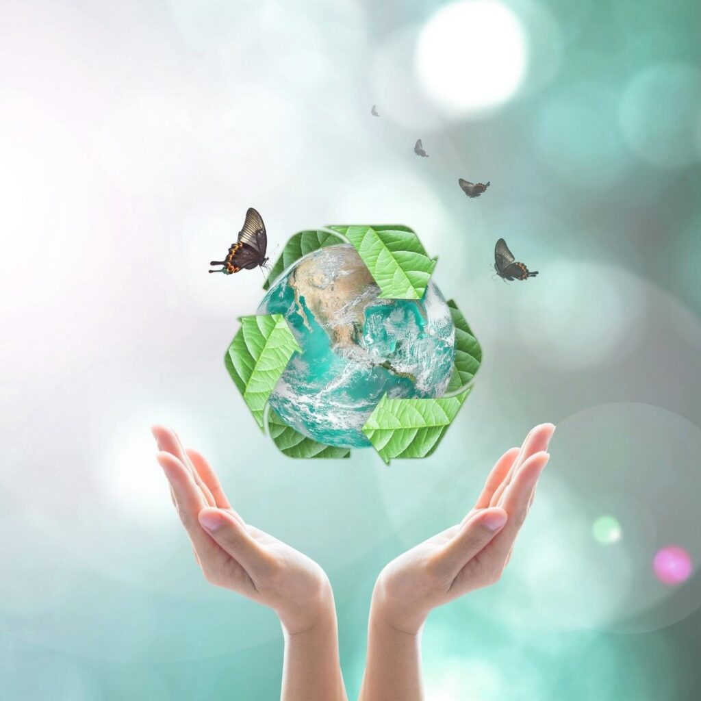 A hand holding a recycle symbol, reminding us to save electricity and embrace energy saving, starting right from the kitchen.