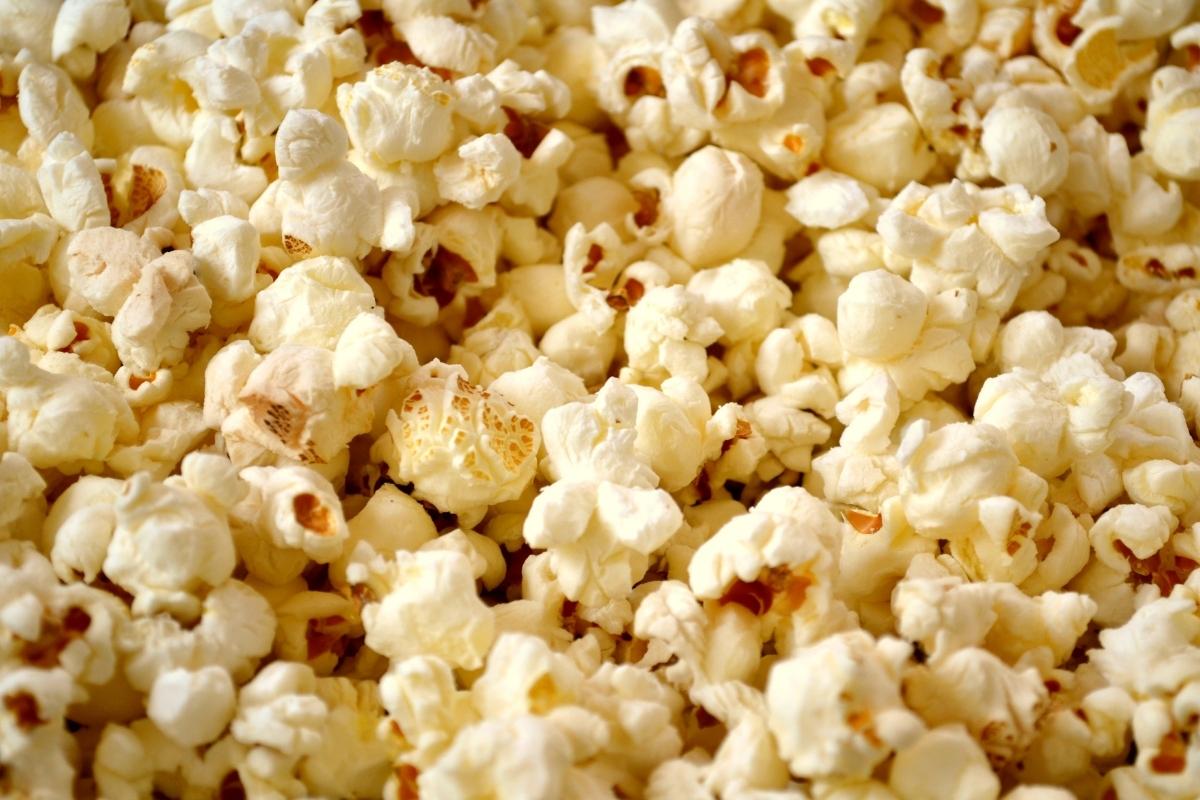 A close-up image of freshly popped popcorn shows fluffy, white kernels with golden edges, perfect for cheap snack ideas. Light and crisp, with hints of caramelised bits, this treat is an ideal choice for on the go snacks.
